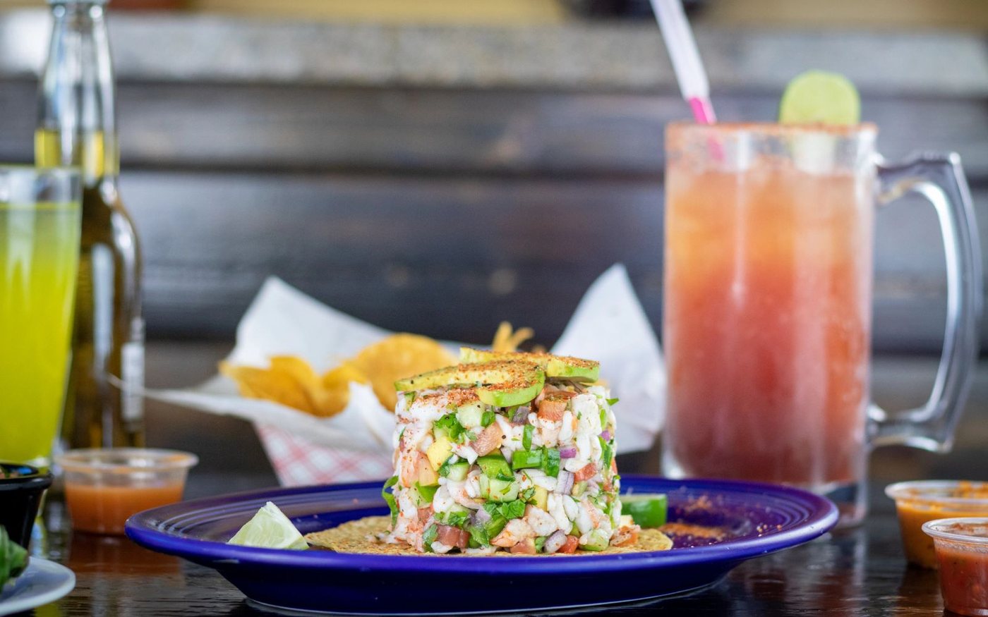 An iGuey seafood tower with chips, salsa and a cold drink